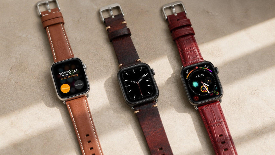 Three Leather Ward leather Apple Watch bands arranged on a warm neutral surface