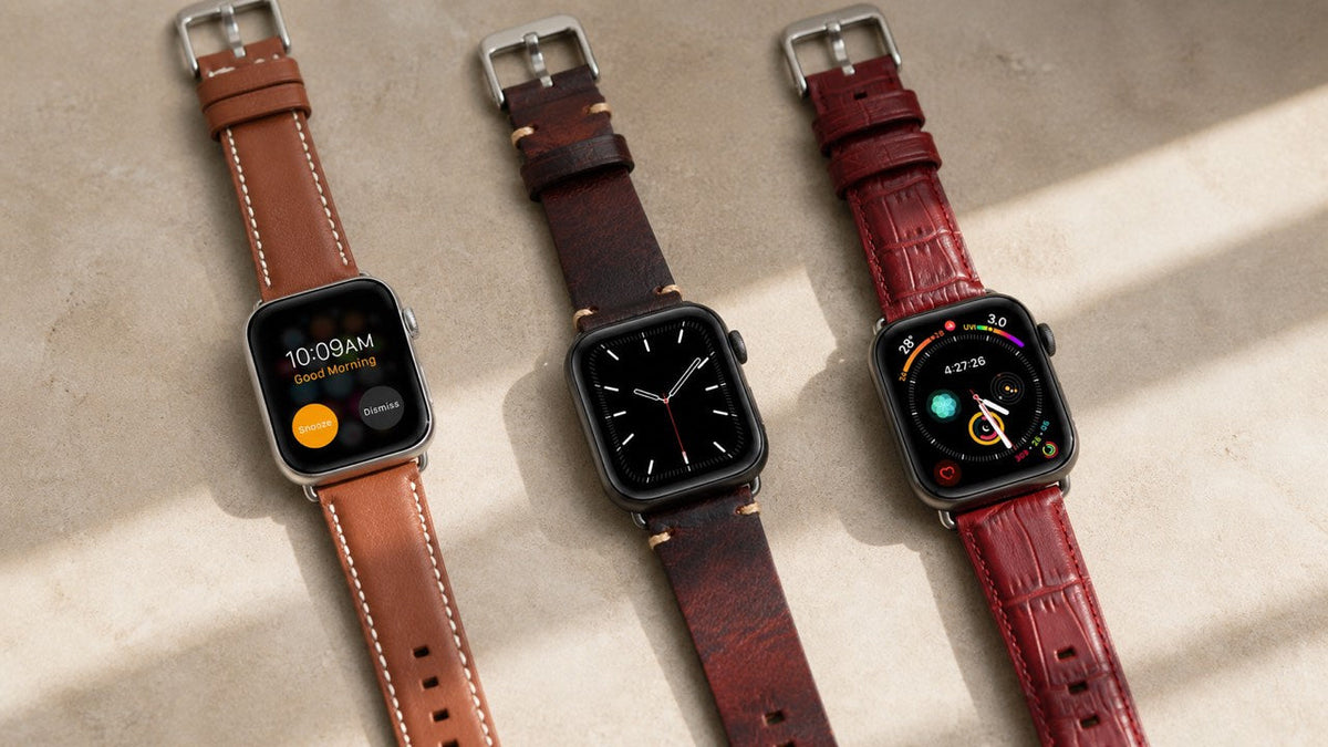 Three Leather Ward leather Apple Watch bands arranged on a warm neutral surface