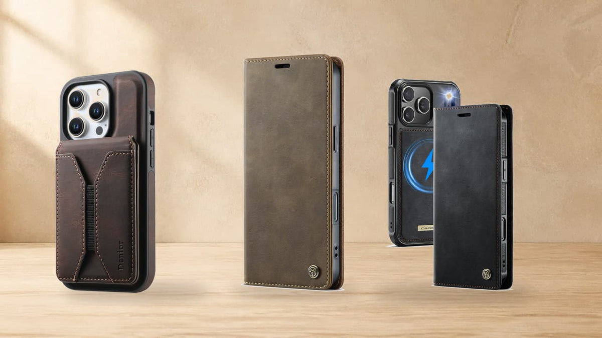 Three Leather Ward iPhone cases arranged on a natural wood tabletop