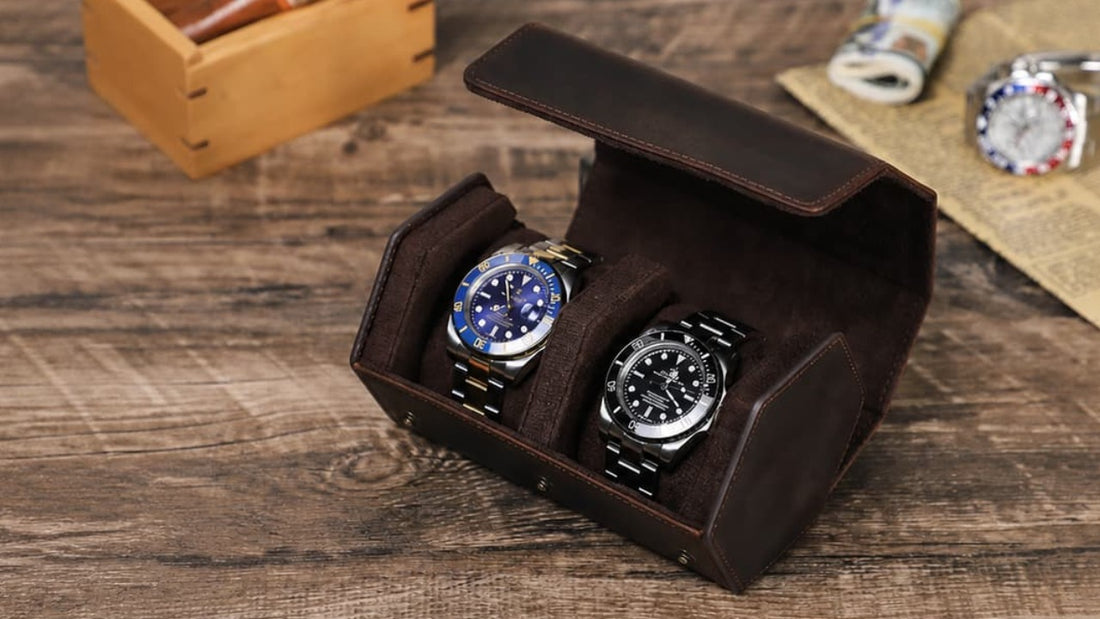 Open Crazy Horse leather travel case holding two watches on a wooden table